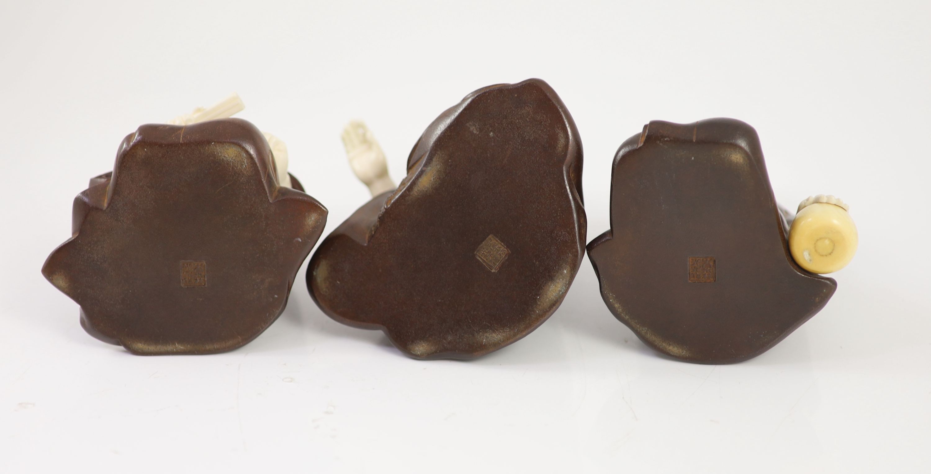 A set of three Japanese bronze and ivory okimono of ‘Go’ players, Meiji period,